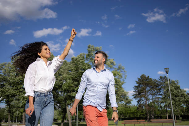 istock Young Caucasian couple flying a kite outdoors in nature 1318863590