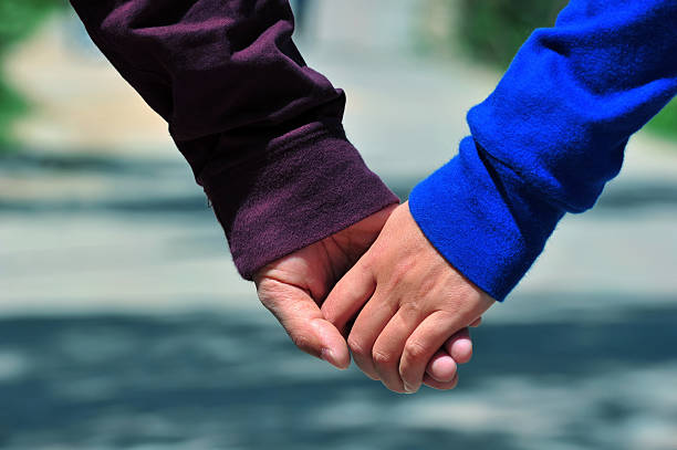 istock Couple holding hands on beach 131886429