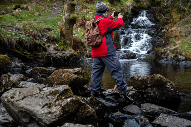 istock Senior man taking a photograph with his phone 1318864996