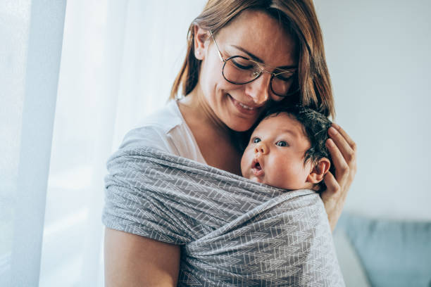 istock Young mother with her son in sling. 1318865044