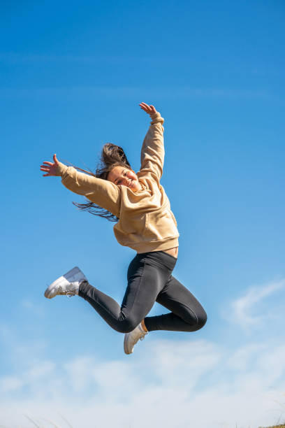istock Thirteen year old mid-air outdoor portrait 1318866056