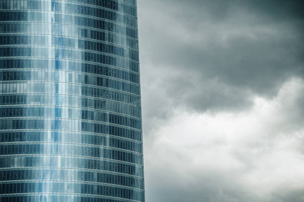 A modern office building on a dark, stormy day with thick clouds