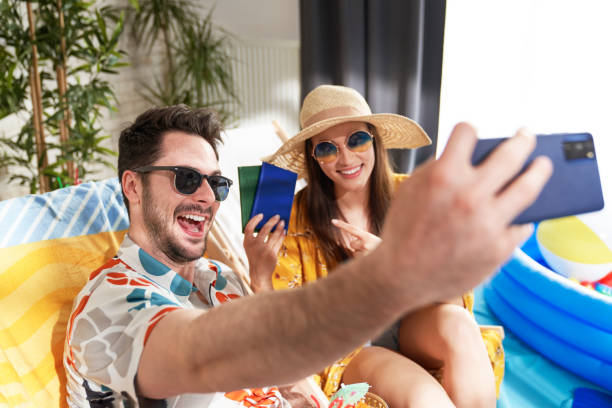 istock Happy couple taking a selfie on vacation at home 1318866314