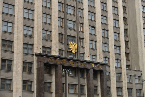 Moscow, Russia - May 4, 2021: Golden coat of arms of Russia on the building of the State Duma. Building of The State Duma of Russian Federation in Moscow, Russia.