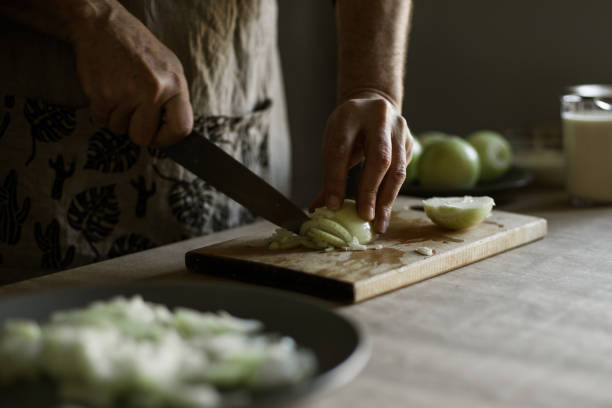 istock Male hands cutting onions 1318872479