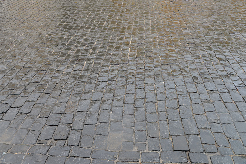 Abstract background. Old cobblestone pavement closeup.