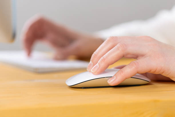 istock Close-up of young female hands pressing keyboard buttons and using a mouse. work from home. office. shopping 1318874095