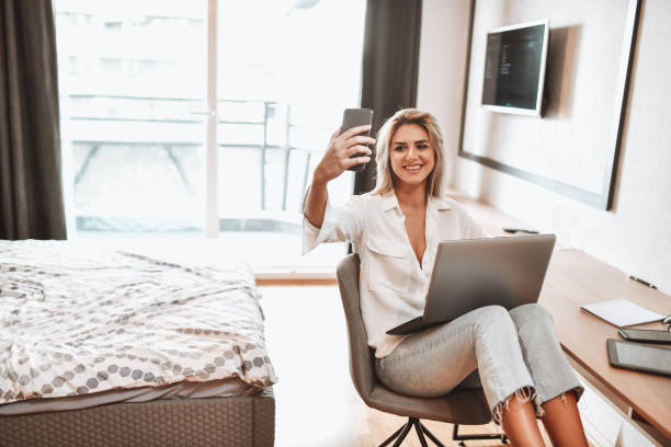 istock Female Beauty Taking Selfie While Working At Home Bedroom 1318874458