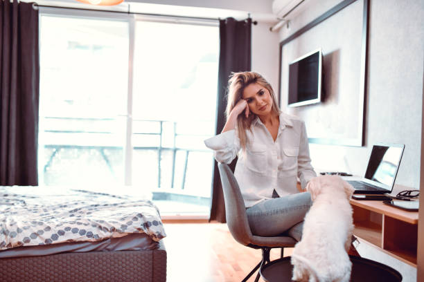 istock Smiling Female Beauty Getting Bother By Puppy While Working 1318874479