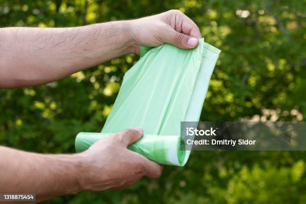 Holding Eco Plastic Garbage Bio Bag In Roll Outdoors Stock Photo - Download Image Now