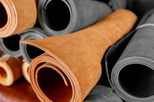 istock Full frame of brown and black textile genuine leather rolls. 1318875650