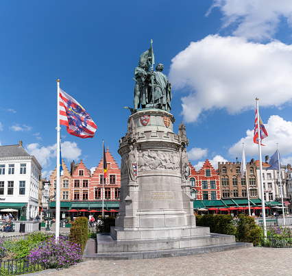 Bruges, Belgium - 12 May, 2021: statue of Jan Breidel and Pieter de Coninck in the Market Square in the historic city center of Bruges