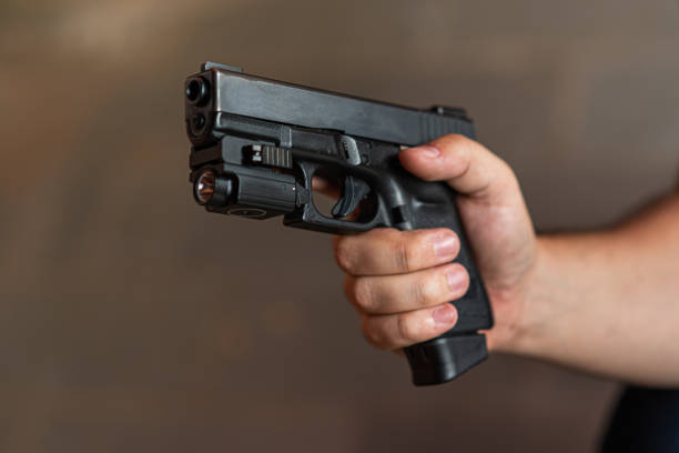 istock White man holding a pistol 1318875791