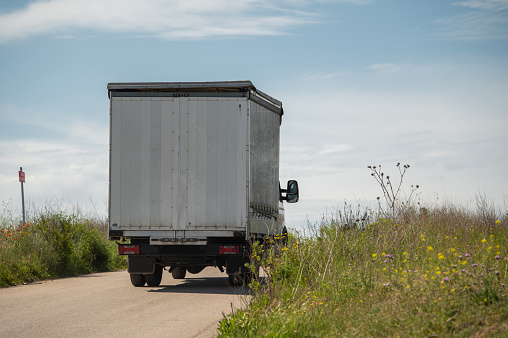 Rear view of a small truck on a country road