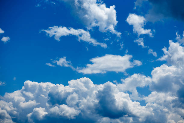 Blue sky with gathering cumulus clouds over the city of Nesselwang in Bavaria in summer 2018.
