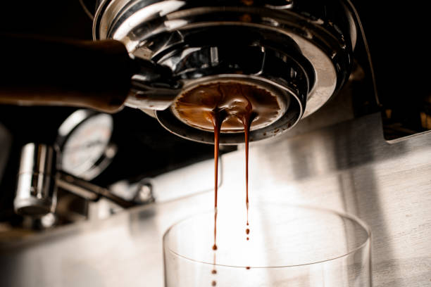 istock bottom view on portafilter of coffee machine from which drink flows into glass 1318878220