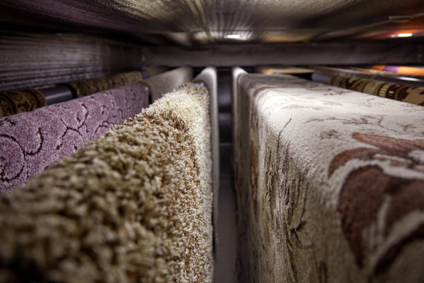 istock Different carpets hanging on racks. Professional carpet cleaning and drying 1318880603