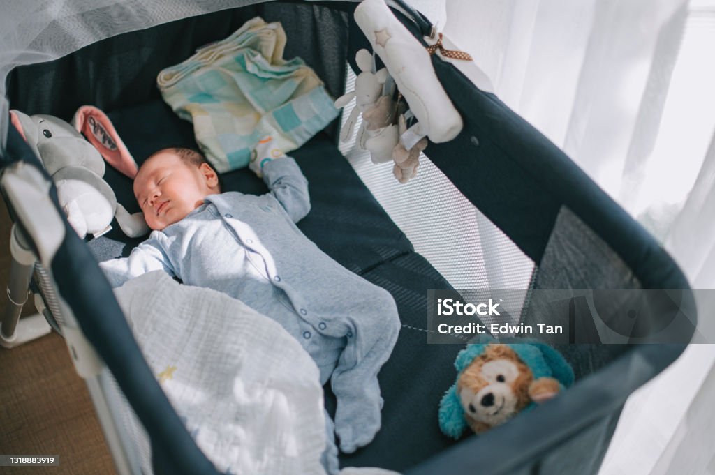 high angle view asian chinese baby boy sleeping in a crib Crib Stock Photo