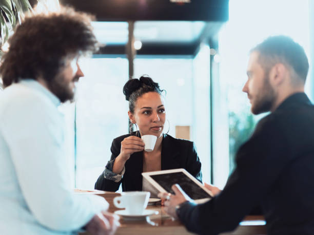 istock A group of business people on a coffee break use laptops, tablets and smartphones while discussing new business projects. 1318886142