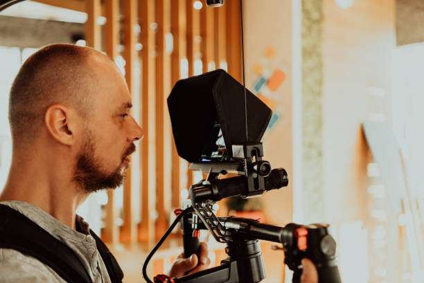 istock Cameraman working on professional camera taking stock footage 1318886568