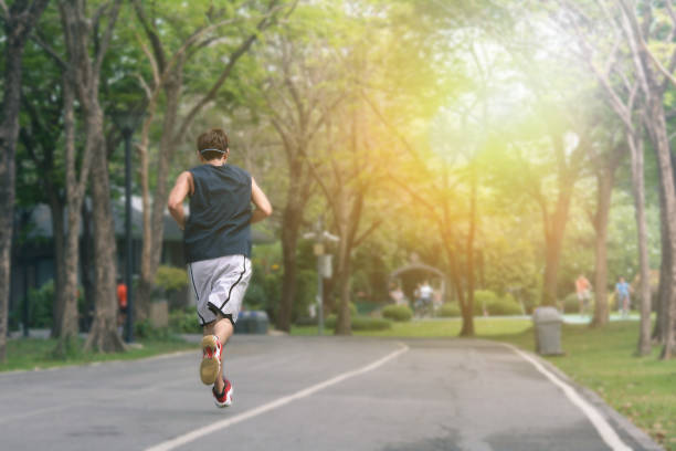 istock Athletic Young Running man. Male runner jogging at the park. Guy training outdoors. Exercising on forest path. Healthy, fitness, wellness lifestyle. Sport, cardio, workout concept 1318887531