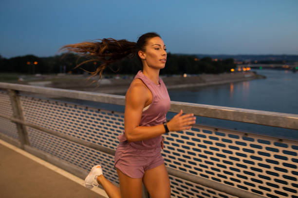 istock Female athlete jogging outdoors on the bridge 1318887812