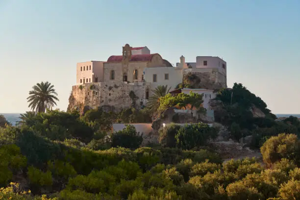 Chrysoskalitissa Monastery on the hill surrounded by walls in dusk with very soft light and mediterranean sea in the background, Peninsula Akrotiri Crete Greece