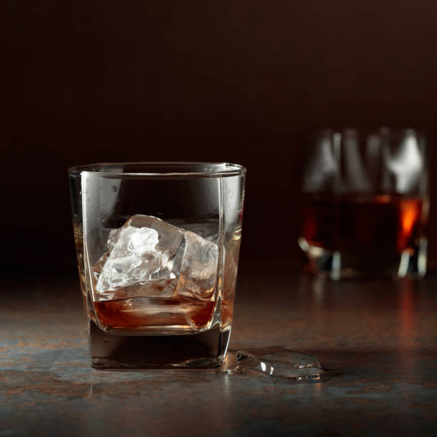 istock Glass of whiskey on a rusty background. 1318891469