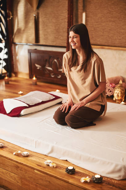 istock Laughing female relaxing on massage bed in salon 1318897020