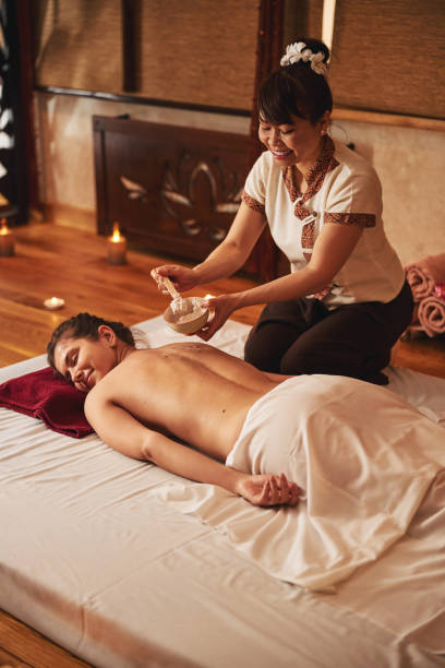 istock Massage therapist putting stick inside bowl and taking massage cream 1318897058