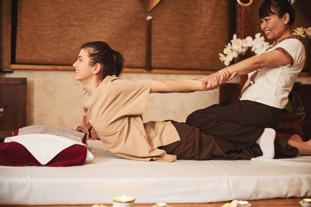 istock Woman bending back with help of Thai massage expert 1318897078
