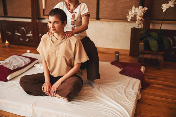 istock Calm woman in lotus pose getting neck massage 1318897132