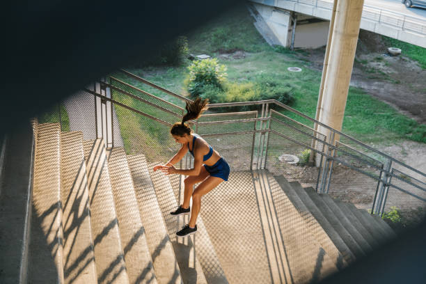istock Fit woman jumping on the stairs 1318897310