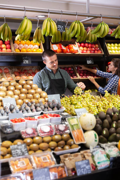 istock Two sellers laying out vegetables 1318898011