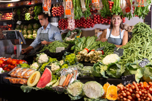 istock Two young sellers working behind the counter 1318898027