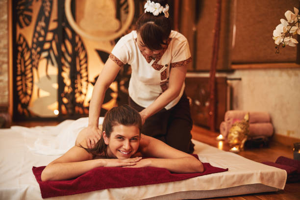 istock Spa centre worker doing shoulder massage to excited woman 1318898153