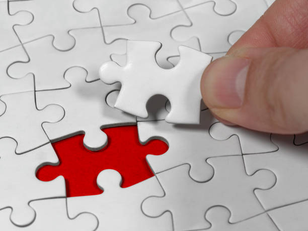 istock Closeup an male hand holding the jigsaw puzzle solution to the problem missing piece. Concept conceptual metaphor imagine. 1318903448