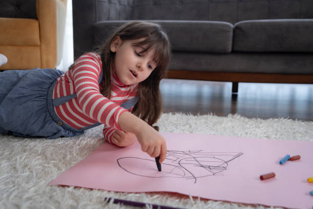 istock Little Girl Painting 1318906713
