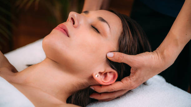 istock Cranial Osteopathy. Therapist Massaging Woman’s Head. 1318911285