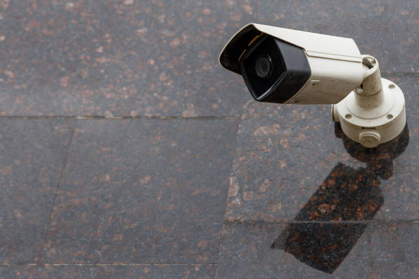 istock small cheap surveillance camera on tan brown granite wall 1318912743