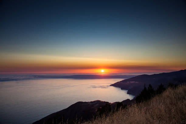 Image taken from a sequence of a fog bank rolling in on Big Sur, California, seen from high up on Prewitt Ridge at sunset.