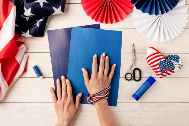 istock Making colorful paper fans, step 1 - preparing all instruments, paper, glue, scissors and thread. Flat lay 1318916905