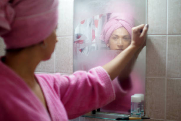 woman coming out of the bathroom personal hygiene vanity mirror stock pictures, royalty-free photos & images