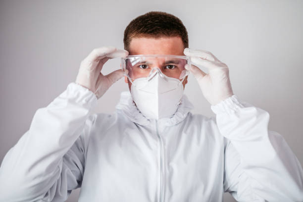 istock Medical worker in protective suit putting glasses on 1318917070