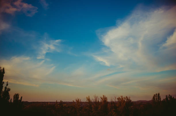 Landscape with dramatic light - beautiful golden sunset with saturated sky and clouds, peaceful nature serene background.