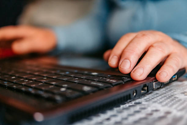 istock Senior hands typing on a laptop keyboard 1318918427