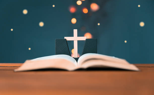 istock wooden cross with open Bible 1318919480