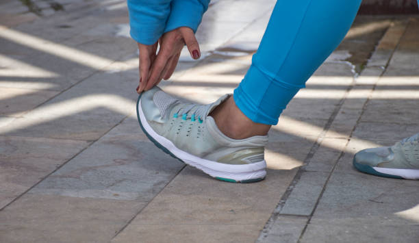 istock Sideways woman touching tiptoes doing exercise 1318922240