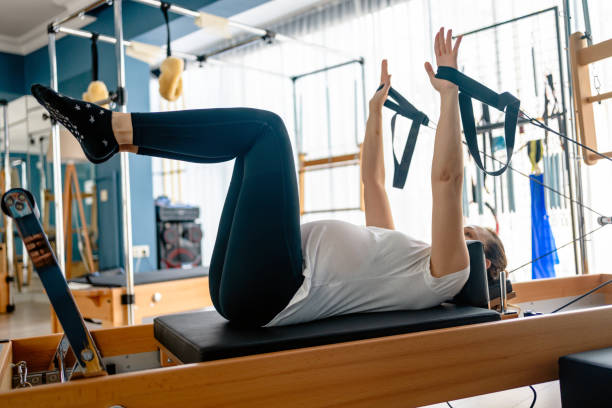 istock pregnant woman working out on a pilates machine 1318923687