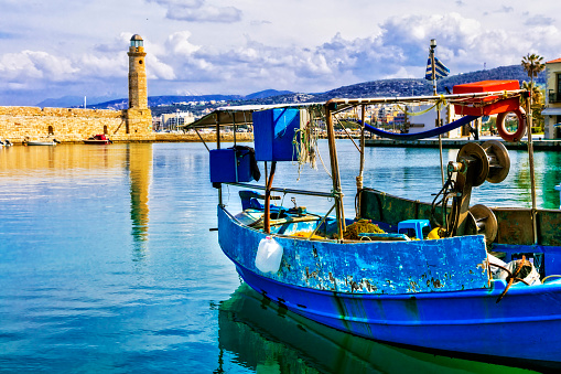 Old harbour of Rethymno town and lighthouse. Colorful fishing boats. Crete island ,Greece